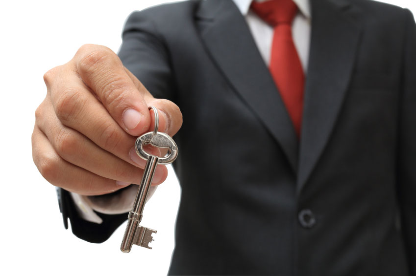 businessman showing the silver key to success isolate on white c
